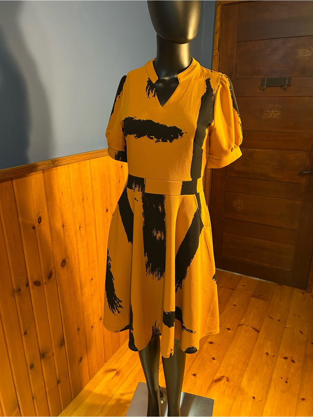 NWT. Burnt orange dress with abstract, black brush strokes. Fit and flare
